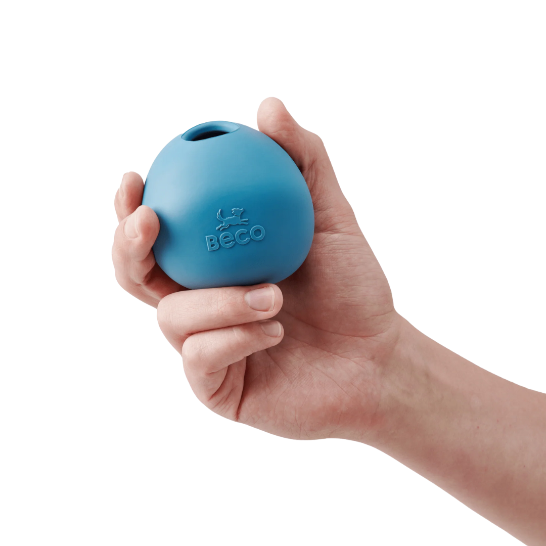 Human hand holding a Beco natural rubber wobble ball.