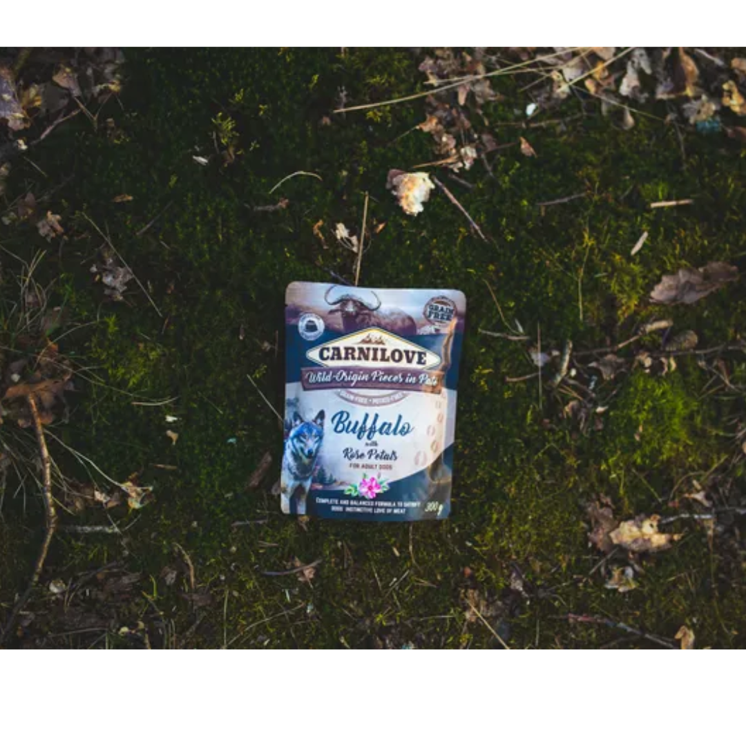 The Carnilove Buffalo with rose petals dog food lying out on the grass for an aesthetic photograph