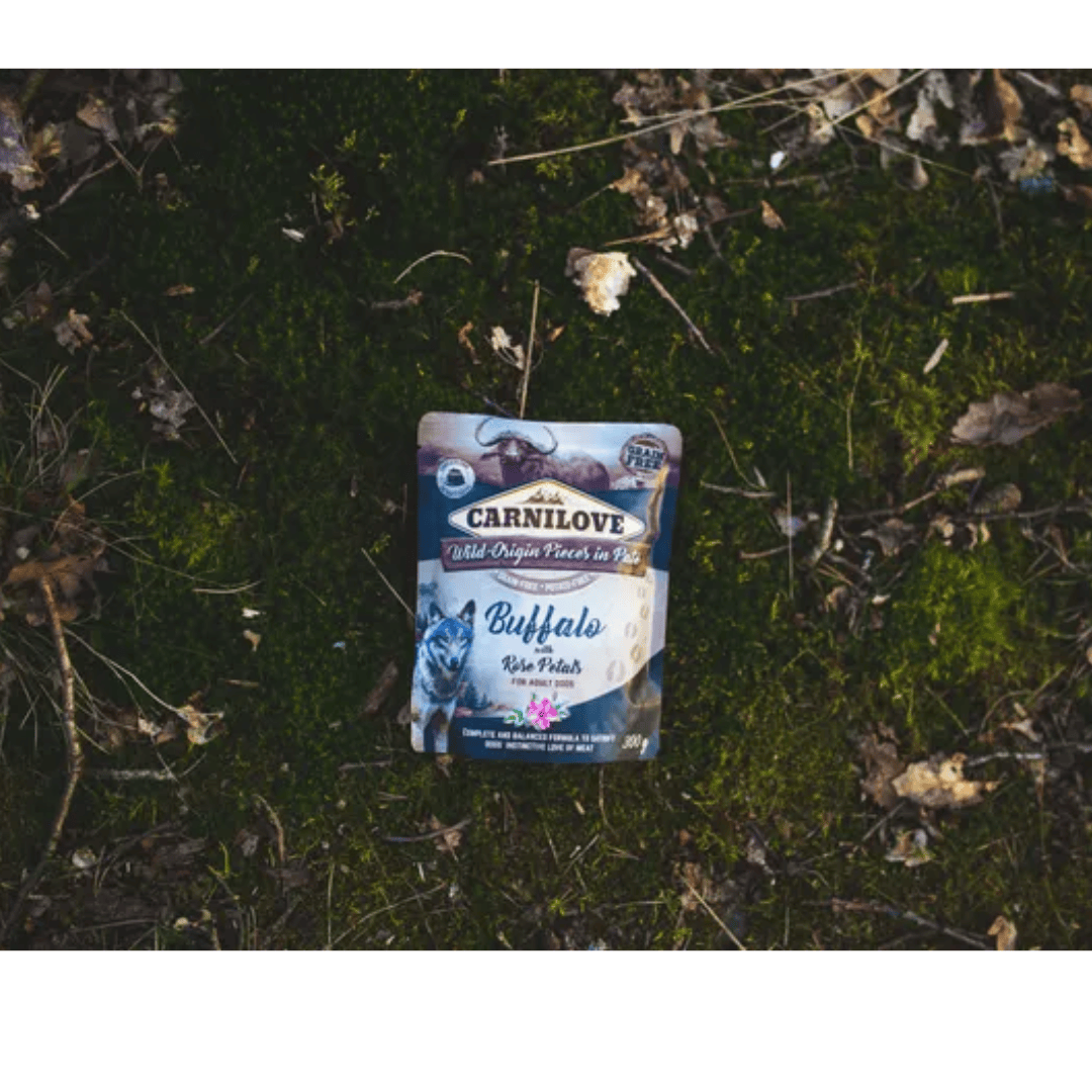 The Carnilove Buffalo with rose petals dog food lying out on the grass for an aesthetic photograph