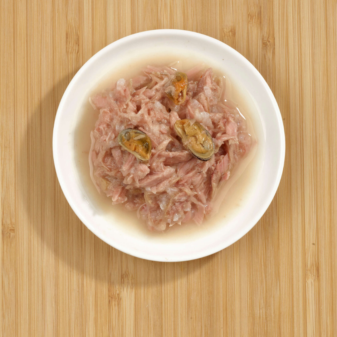 The Fish 4 Cats Tuna with Green Lipped Mussel served on a plate. The tuna, delicious broth, and chunky mussels are clear to see.