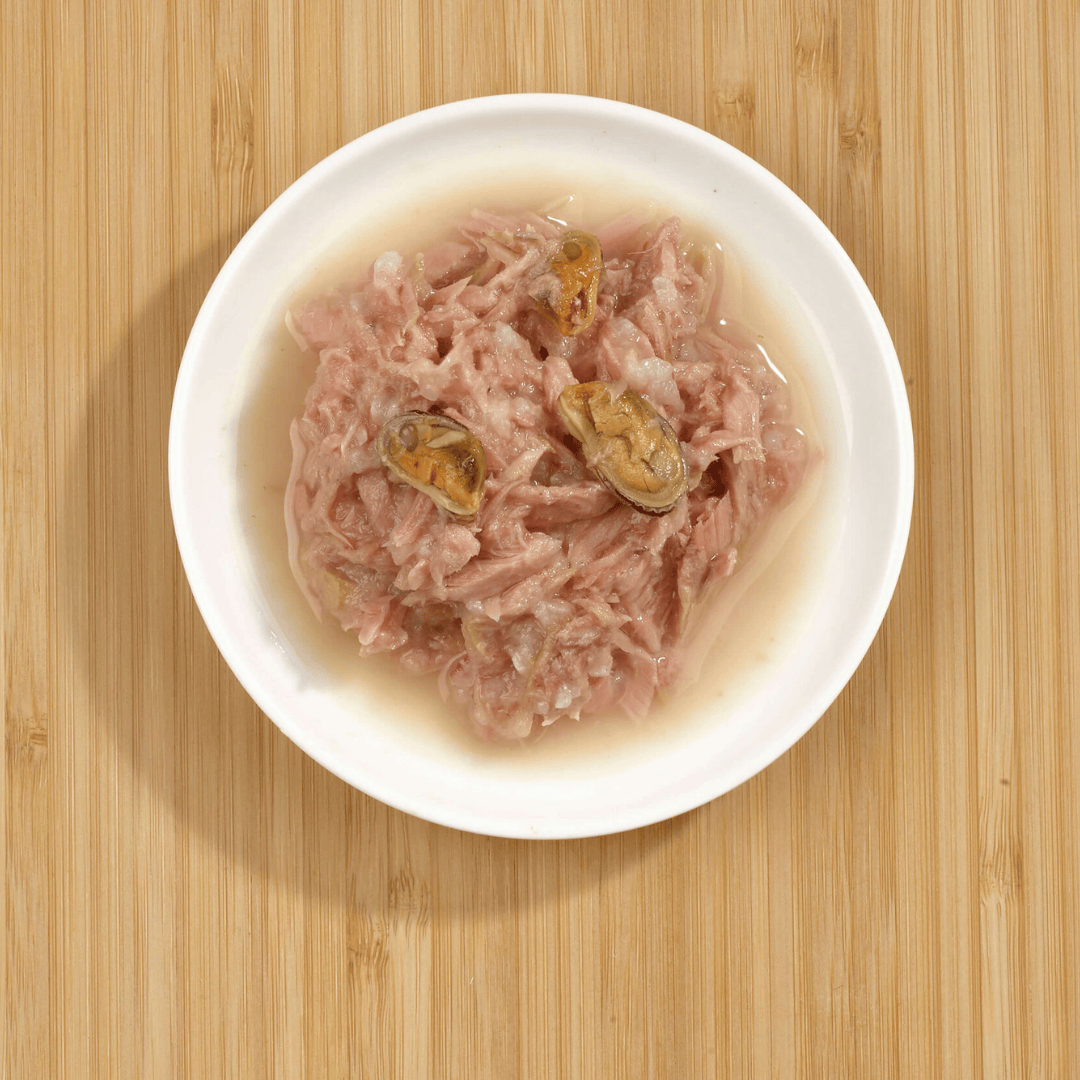 The Fish 4 Cats Tuna with Green Lipped Mussel served on a plate. The tuna, delicious broth, and chunky mussels are clear to see.