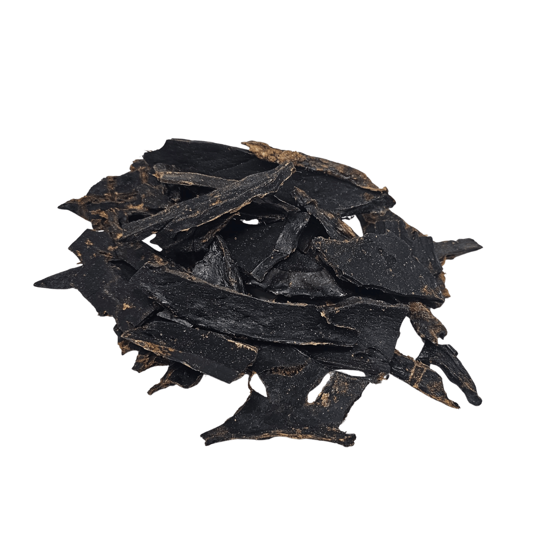 Stack of dried beef liver pieces on a white background