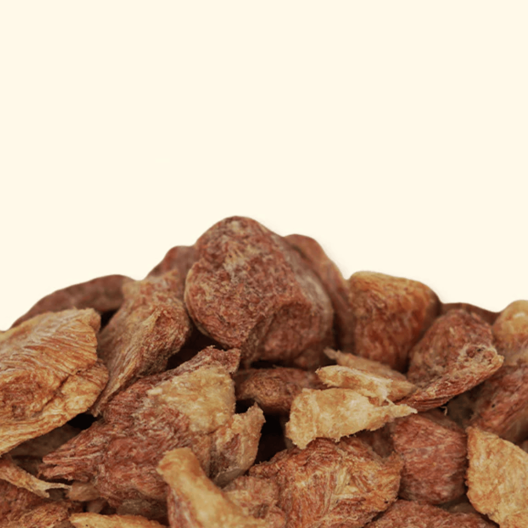 Close-up of dried duck breast pieces on a beige background