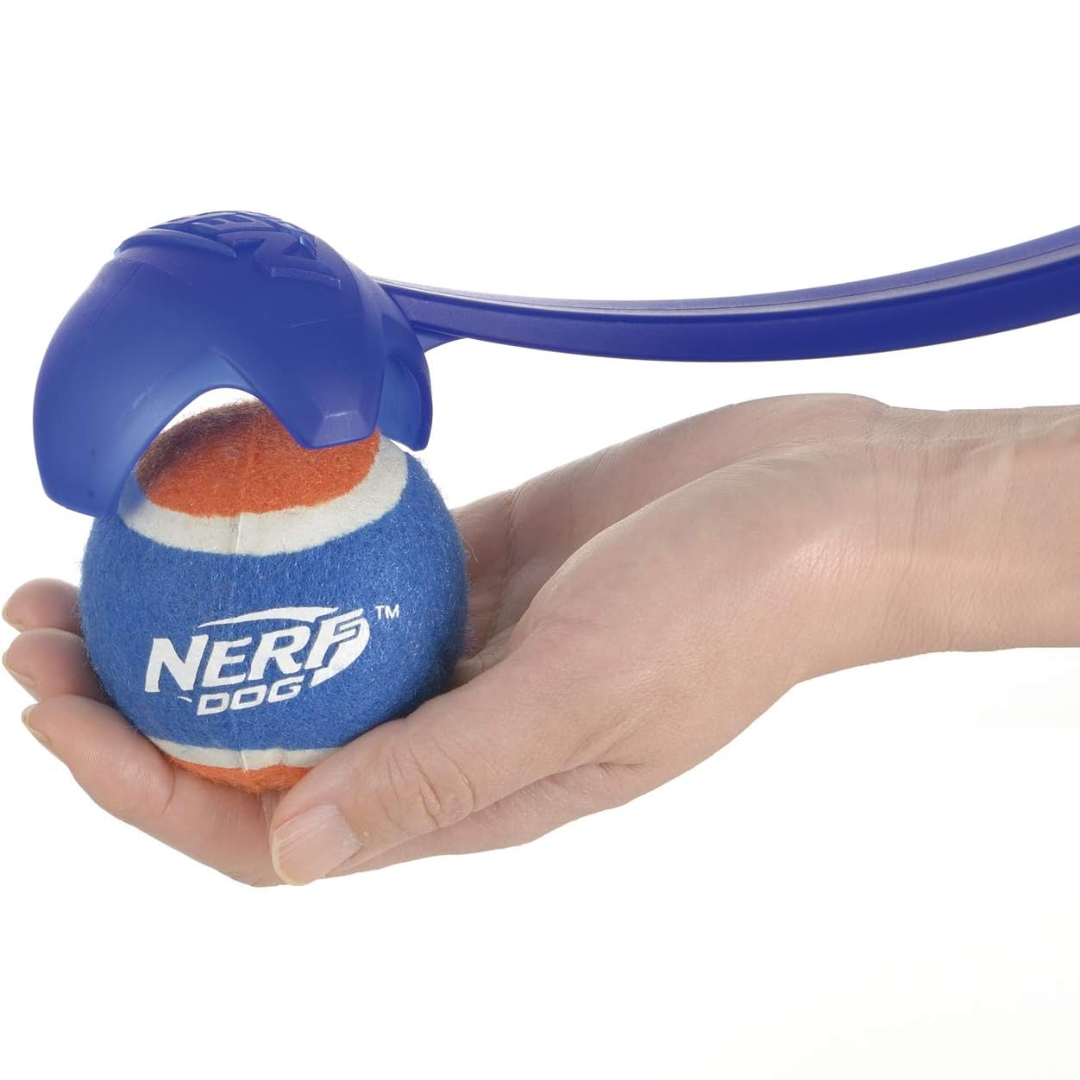 Here you can see the end of Nerf Dog Launcher with a hand holding the Nerf ball below.