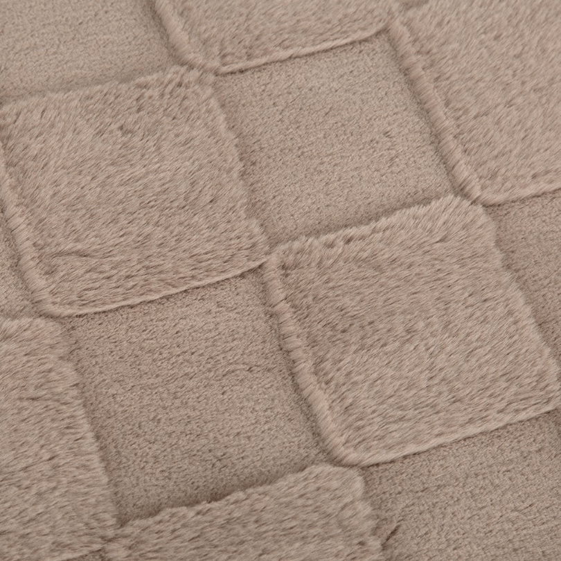 Close-up of the bed with square patterns