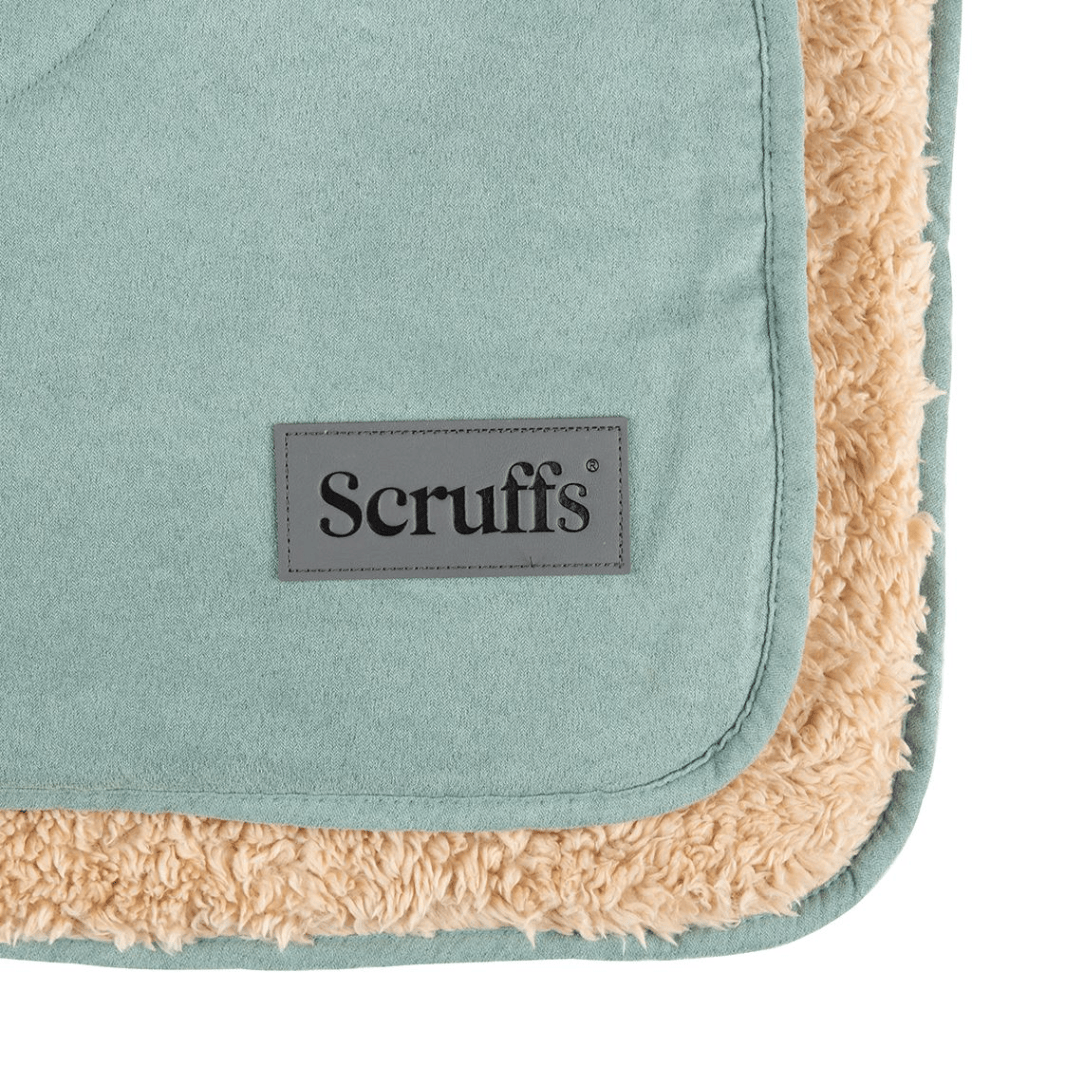 Up close shot of the corner of a sage green Scruffs Snuggle Blanket