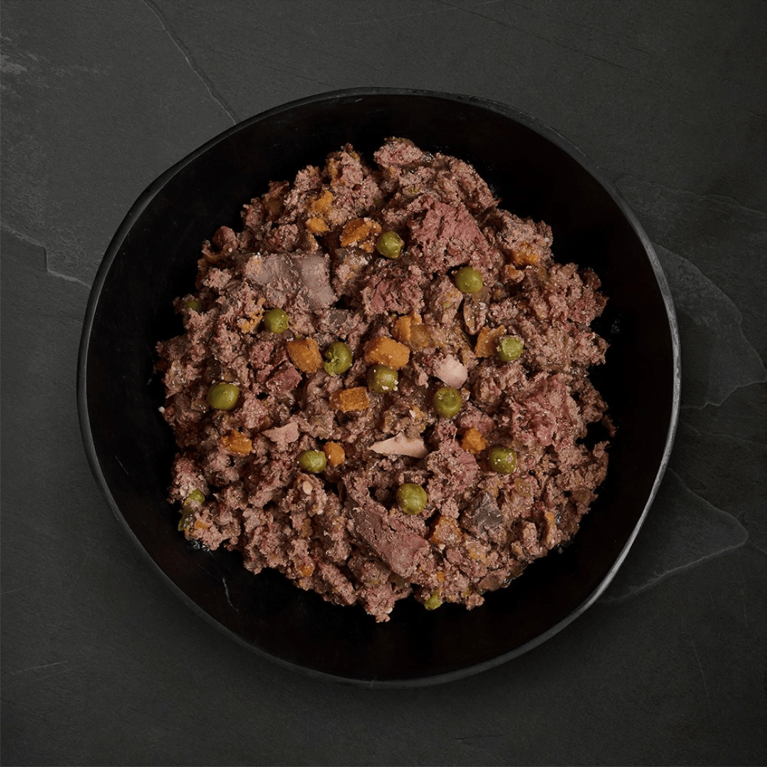 Canagan Shepherd's Pie Wet Dog Food 400g served in a bowl. Chunky Mince like texture with veg.