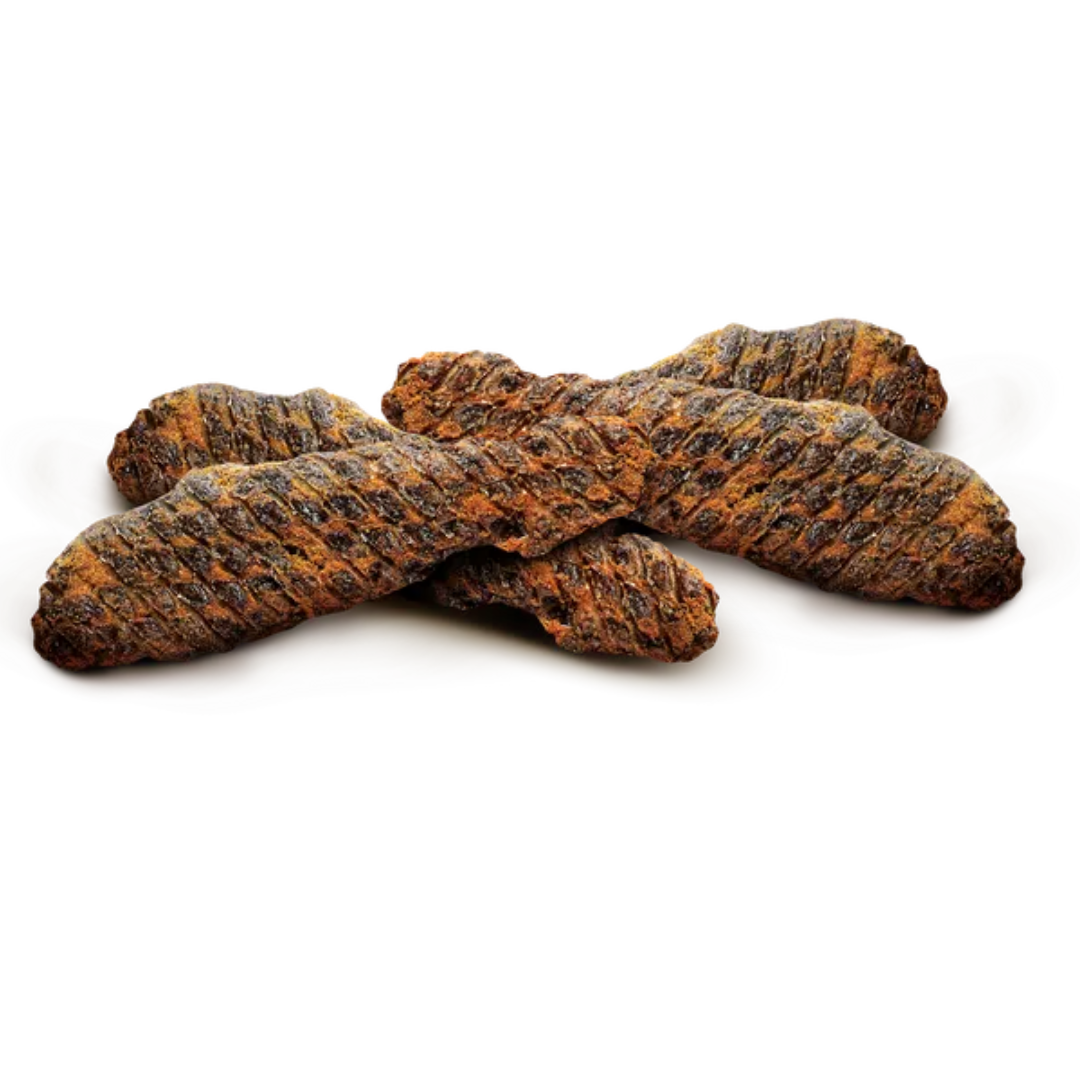 The Carnilove Beef & Beef Muscle jerky dog treats displayed loosely against a white background