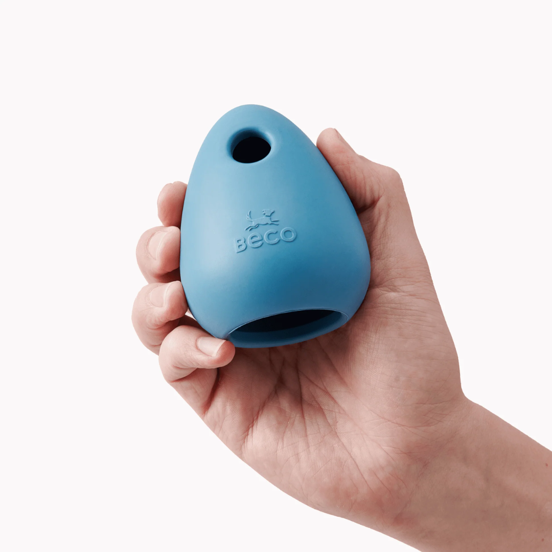 Hand holding a Beco Boredom Buster dog toy.