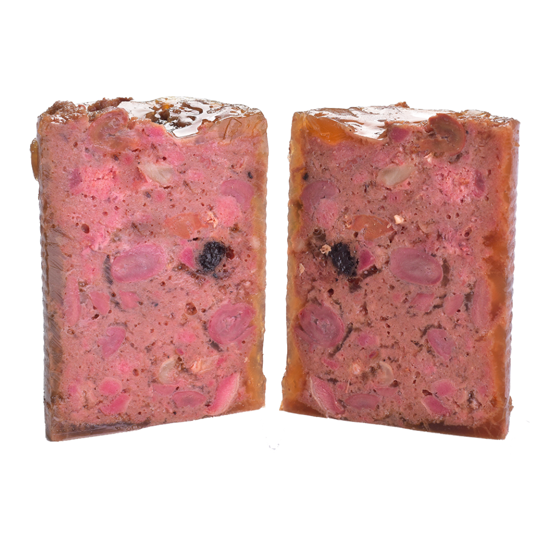 The Carnilove duck& pheasant wet dog food removed from the tin and cut in half to show it's profile. You can see many different textures and ingredients including fruit