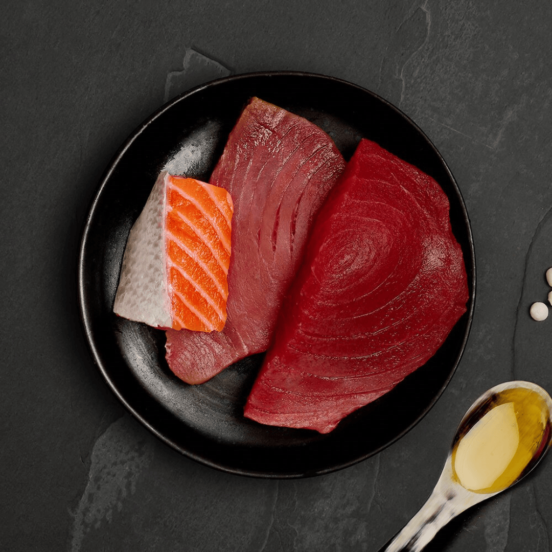 The fresh ingredients of the Canagan Tuna with Salmon Cat Food Tin 75g displayed on a plate