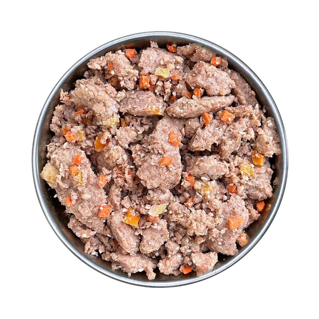 Fidelis pork menu in a metal bowl. Pieces of pork meat and vegetables.