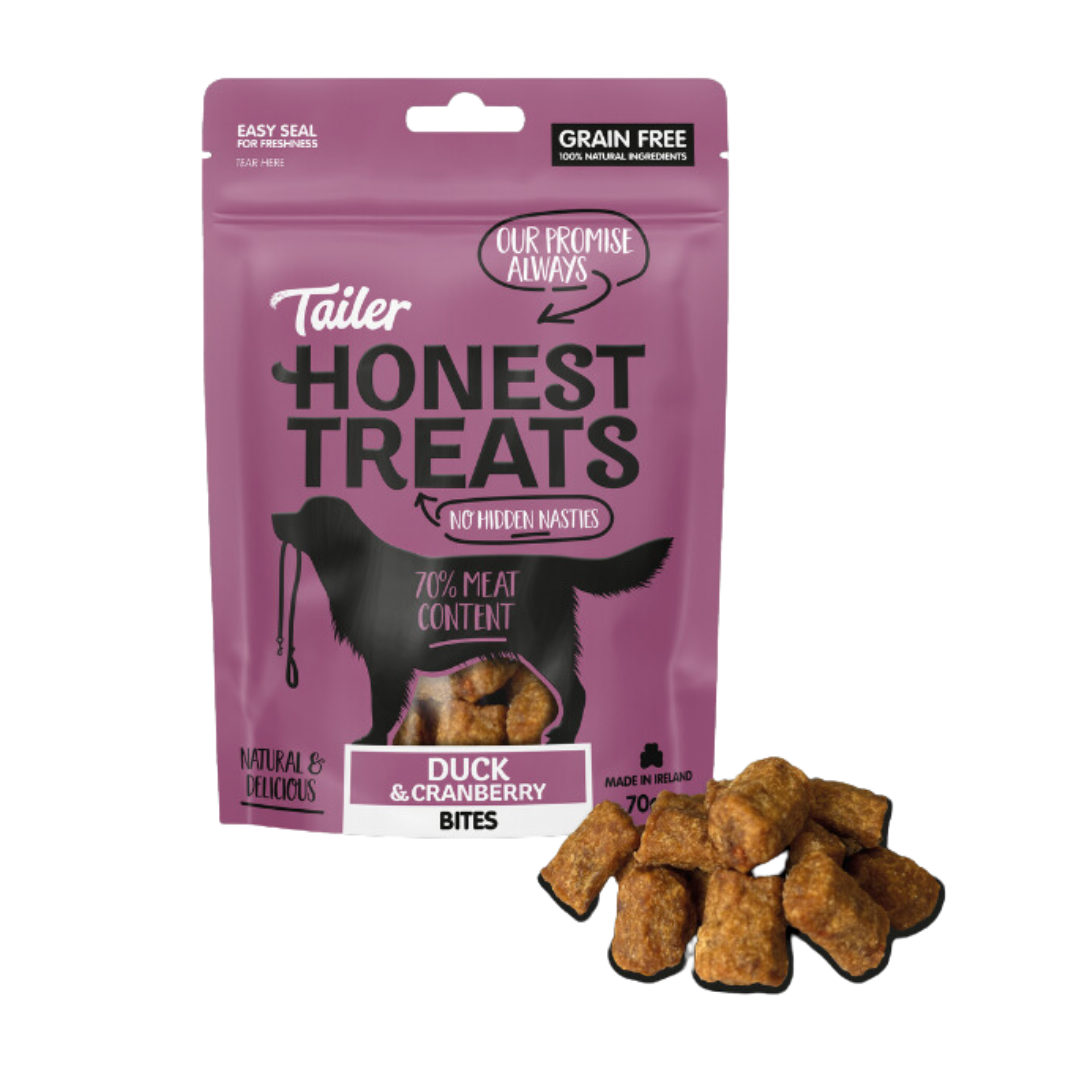 Bag of Tailer Honest Treats behind loose treats.