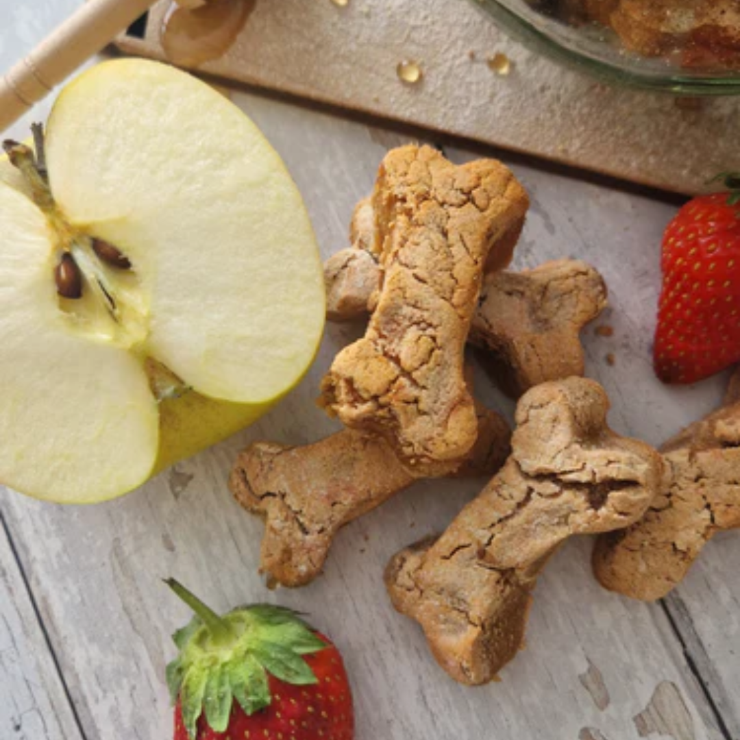 A close up of the Bananas About Butter Happy Tails Barkery Dog Treats and some fresh fruit on display