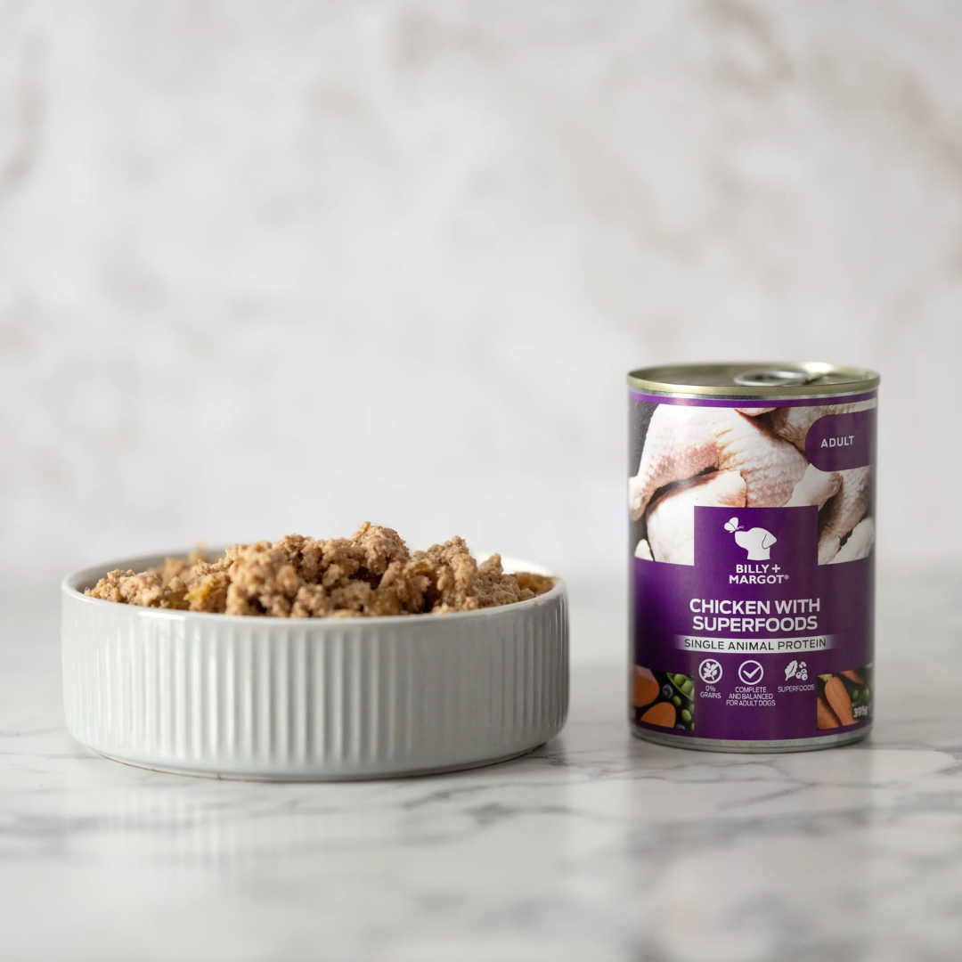 Billy & Margot Chicken with Superfoods Tin beside a ceramic dish full of the same food.