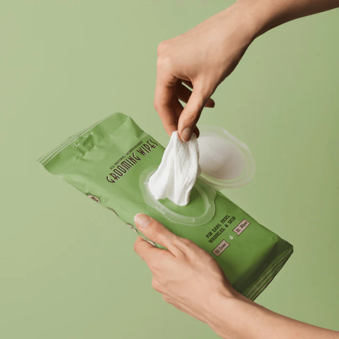 Wipe being removed from a pack of Natural Dog Company Grooming Wipes