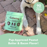 Hand holding a tub of Calming Chews for Dogs with the text "Pup-Approved Peanut Butter & Bacon Flavour"