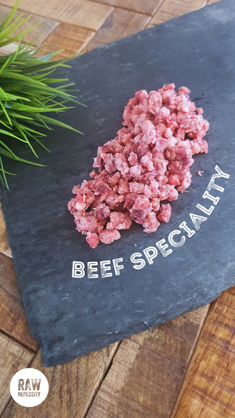 Raw Necessity Boneless Beef Speciality on a piece of slate.