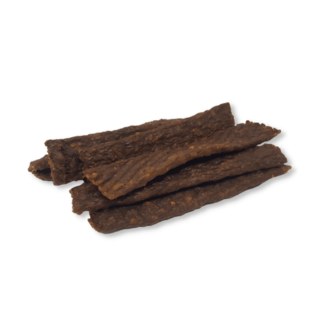 Dried pheasant strips stacked on a white background