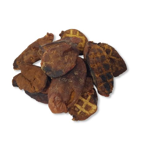 Dried beef testicles dog treats with waffle pattern on a white background