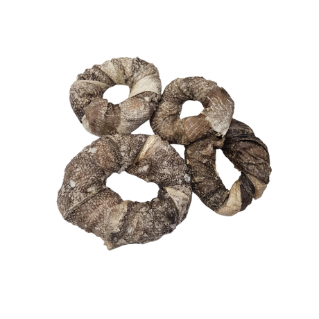 Dried cod skin rings in an assortment sizes against a white background