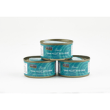 Three cans of tuna fillet with crab on a white background