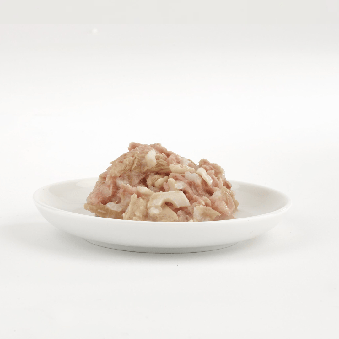 Fish 4 Cats Tuna with squid Cat Food served on a white plate with a white background