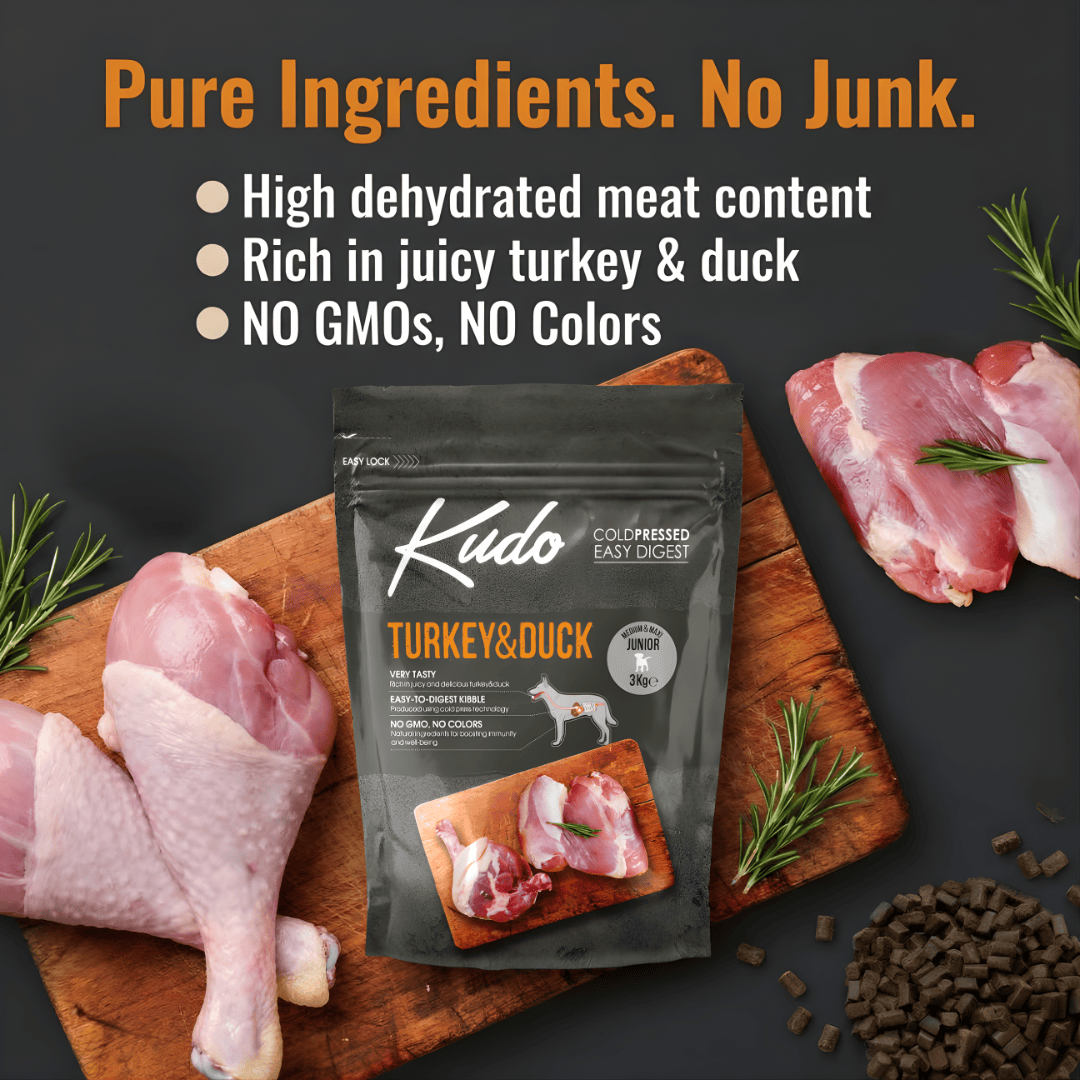 Kudo cold pressed dog food turkey and duck pet food package on a wooden board with raw meat and herbs.