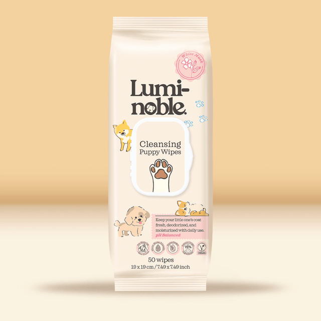 Luminoble cleansing puppy wipes packaging on a beige background