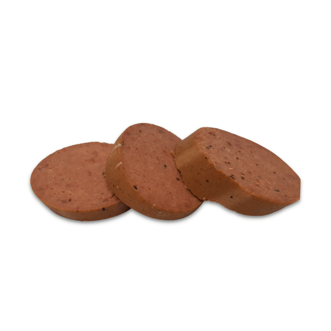 Sliced portions of beef pate on a white background