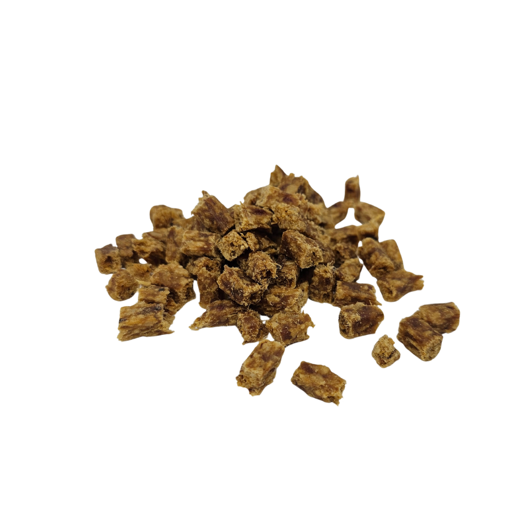 Brown dried turkey cubes on a white background