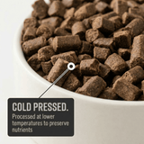 Close-up of a bowl filled with Kudo cold pressed pet food, with text indicating processing details.