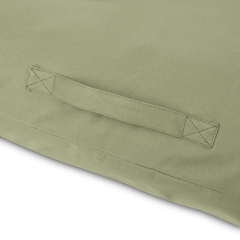 Close-up of a green fabric with a handle detail sewed in on a white background