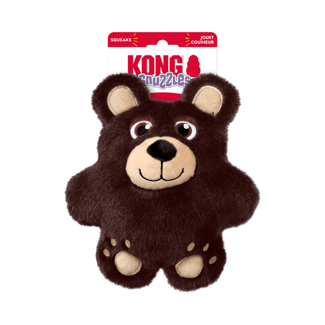 A brown plush Kong Snuzzles bear dog toy with beige facial features and paws, attached to a red and white KONG brand hang card, on a plain white background.
