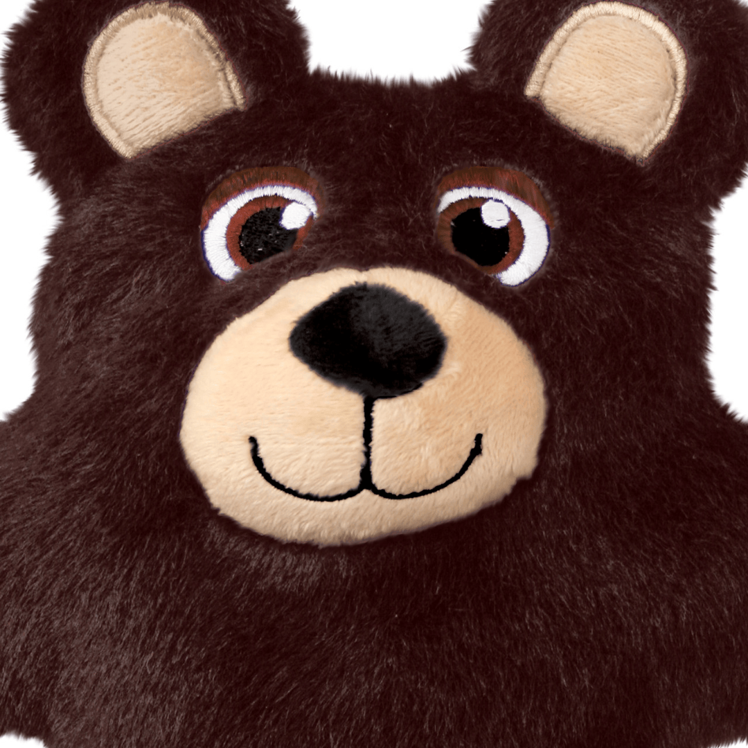 Close-up of a plush bear face in dark brown with a beige snout, black nose, and embroidered eyes on a white background.
