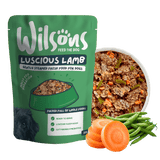 Wilson's Luscious Lamb dog food package with a bowl of dog food, carrots, and green beans on a white background
