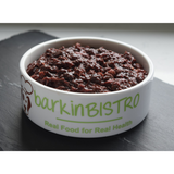 Minced raw venison liver in a white dish with the writing "Barkin Bistro Real Food for Real Health".