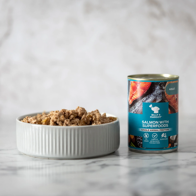 Billy & Margot Salmon with Superfoods in a bowl, to the left of a full tin.