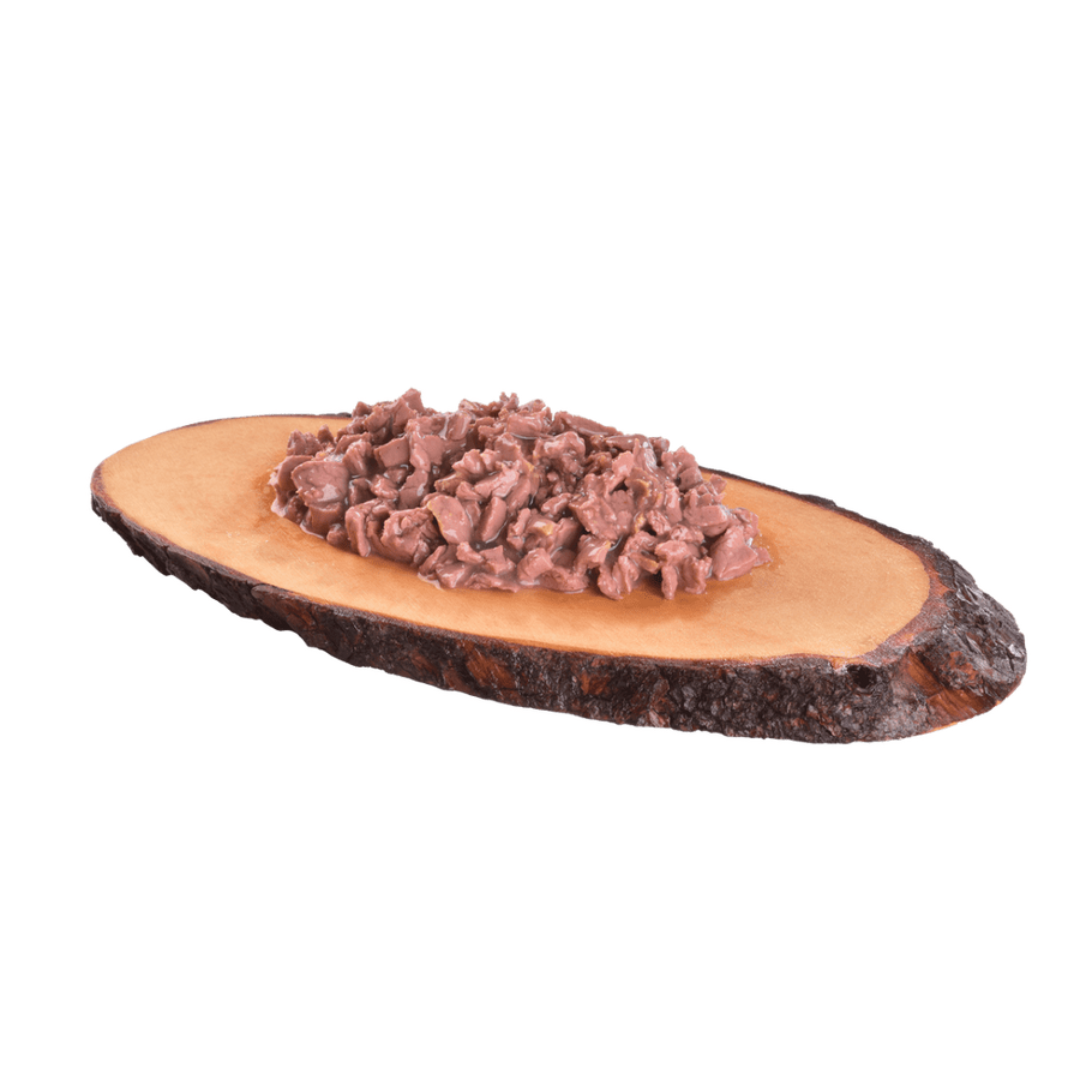 The Carnilove Wet Cat Food Pouch in Duck with Catnip served on a wooden dish. Food is a chunky consistency with broth. 