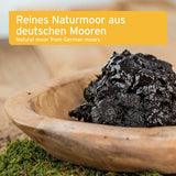 Natural peat from German moors in a wooden bowl with text overlay.