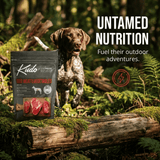 Dog jumping over a log with Kudo dog food packaging beside them in a forest setting, featuring 'Untamed Nutrition' text.